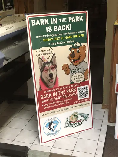 Dog-park event sign with a husky photo